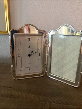 A double-hinged folding silver-plated desk clock and picture frame set.